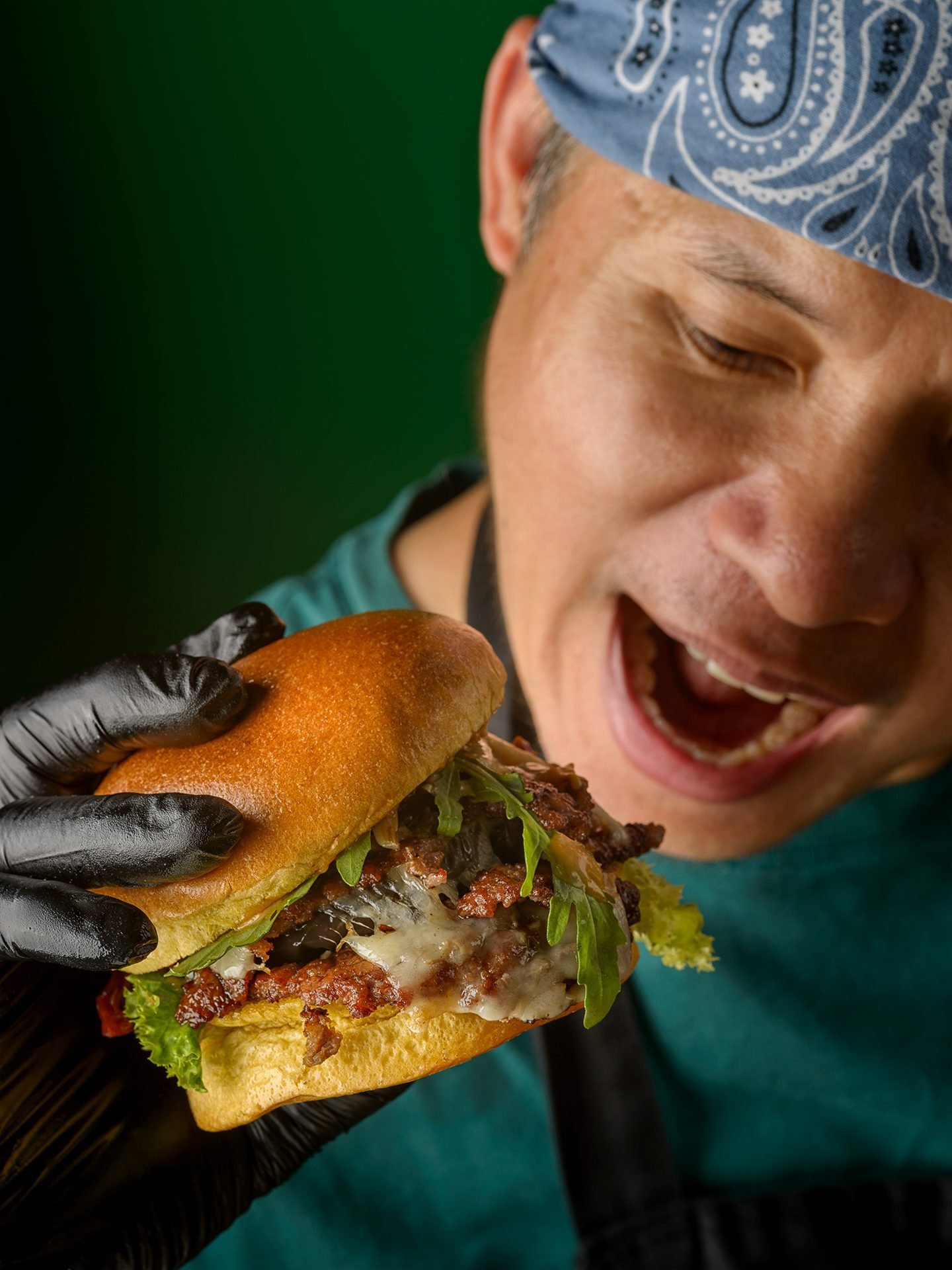 KOYA chef holding a smash burger